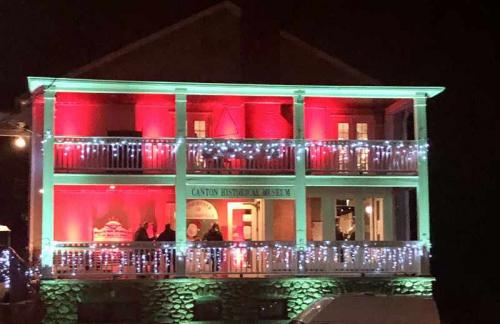 The Canton Historical Museum's balcony lit up with holiday lights.